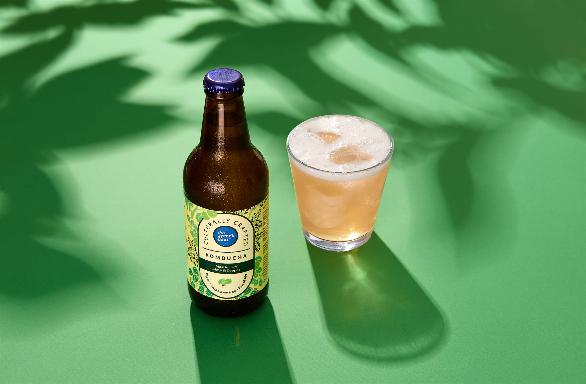 The Greek Gut Mastic Lime and Pepper kombucha on green summer background