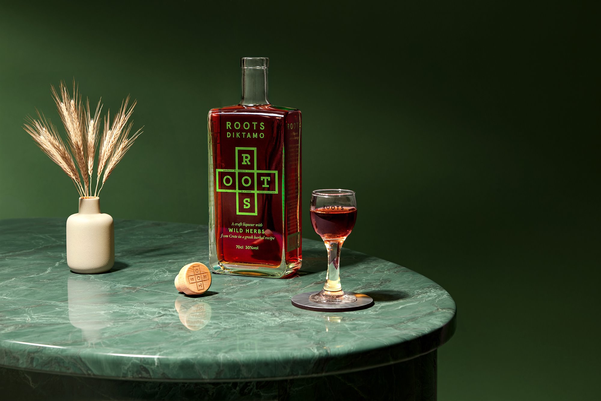 Roots Diktamo spirit bottle on green marble product photography