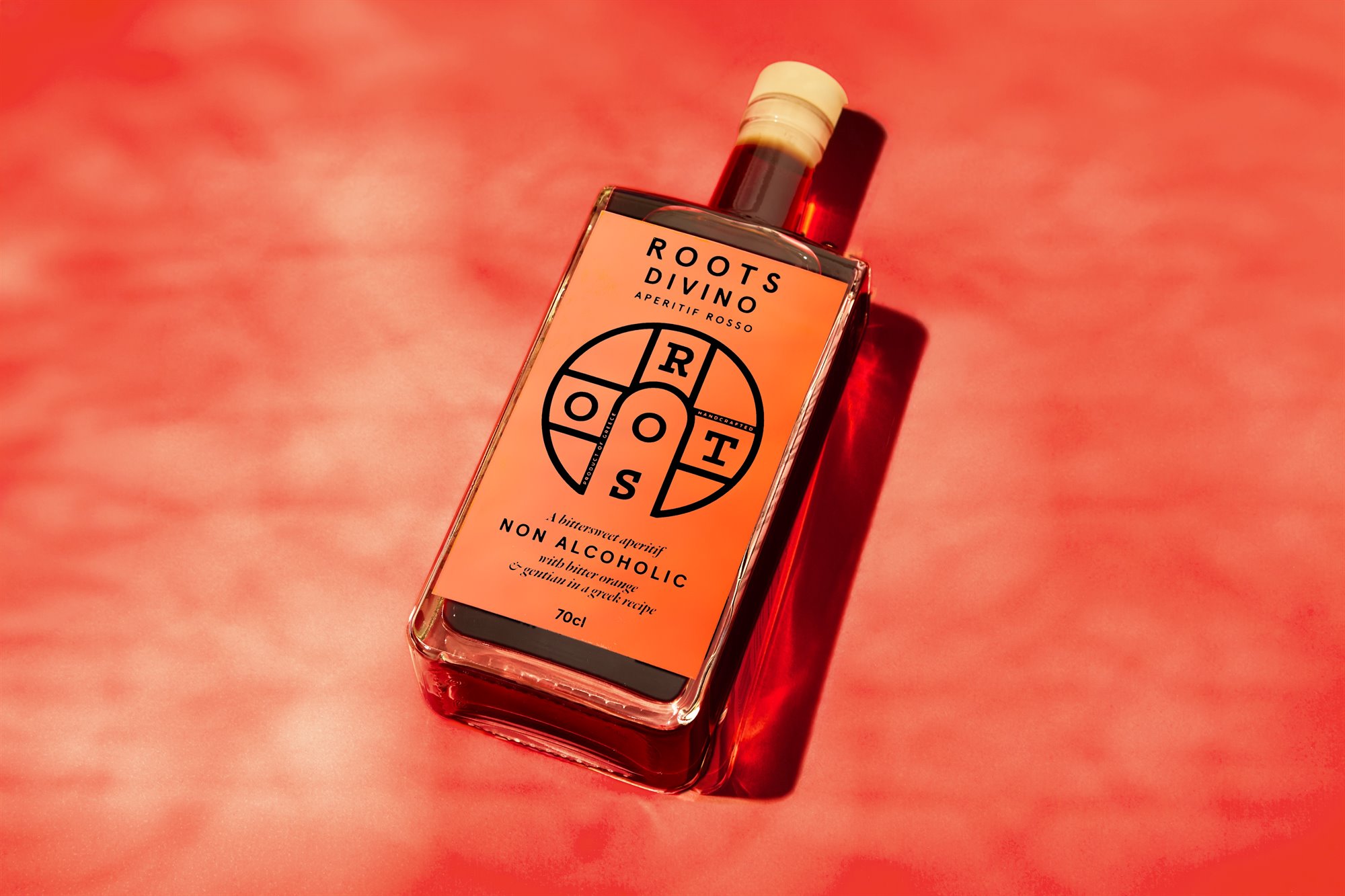 Roots Divino bottle close-up with red water styling